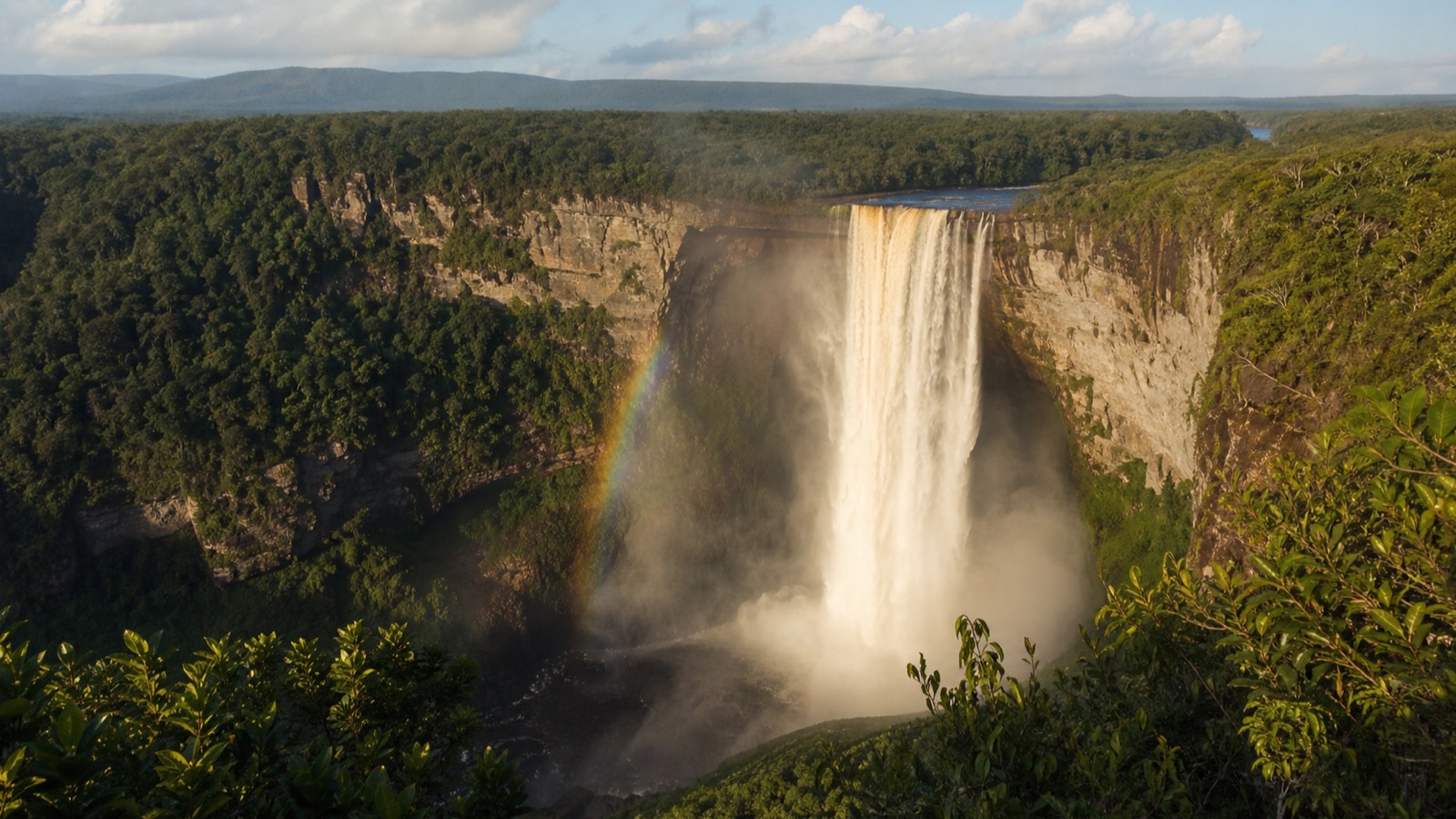Kaieteur Falls plunging off a forested sandstone plateau into a misty gorge